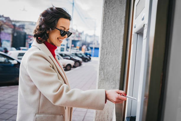 istock A woman uses an ATM 1372951802