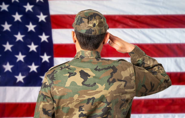 istock man soldier saluting to amercan flag 1372951869