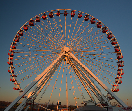 Ferris wheel and blue sky on background