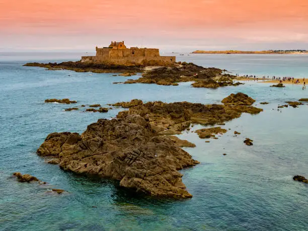 Photo of Saint Malo beach, stunning view of Fort National during low tide, Brittany, France