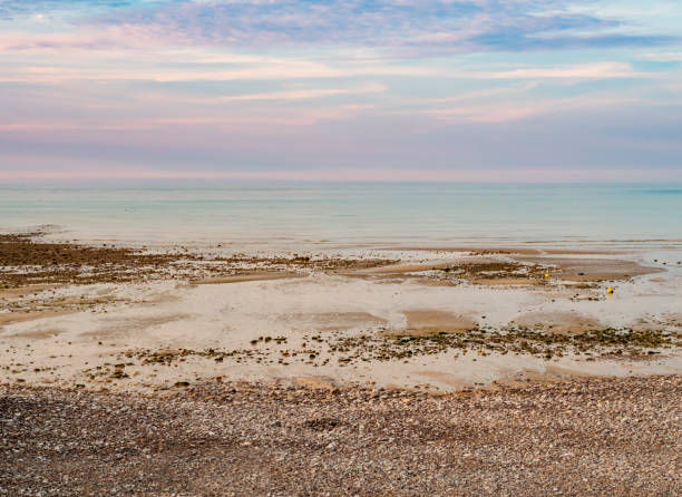 Normandy seascape, gorgeous pastel colors during low tide at sunset, northern France stock photo