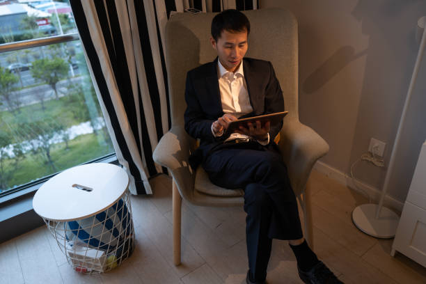 istock High angle view of male businessman sitting and using tablet by window 1372959935