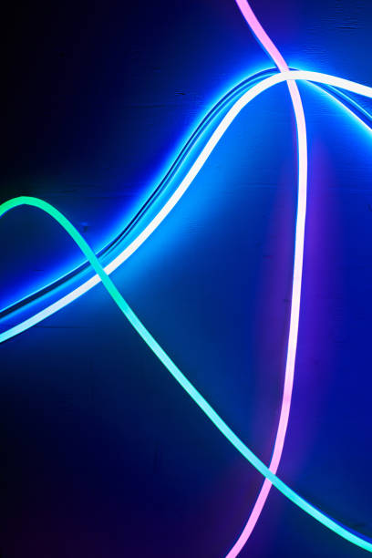 istock neon glowing lines. abstract background. neon curved color tubes 1372962719