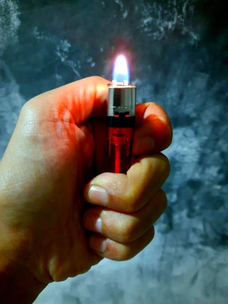 istock a gas lighter lit by someone with his hand 1372963925