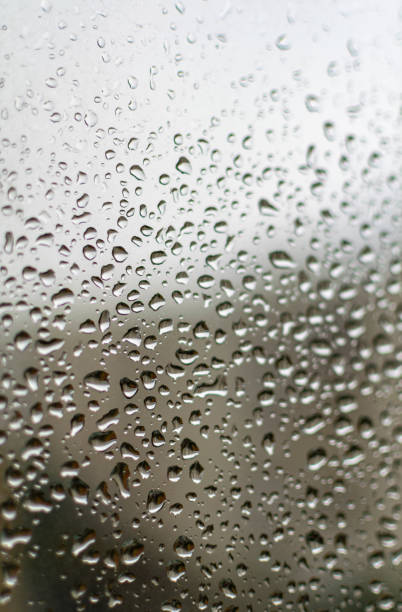 istock Close up image of raindrops on a window 1372967647