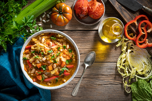 Vegetable Cabbage Soup vegan ingredients as celery, beans, bell pepper, carrots, parsley and roasted tomatoes. Healthy and delicious winter soup, we can switch cabbage for any other crucifer vegetables, plant based diet.