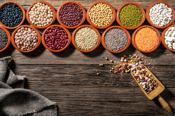 istock Assorted legumes in burlap sacks in a row with wood serving scoop leaving a copy space of rustic wood 1372970146