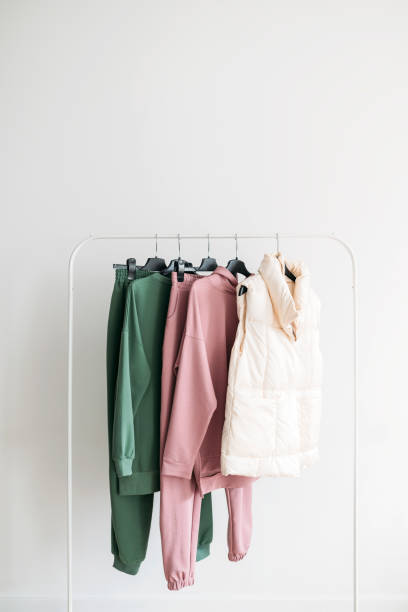 sports wear capsule cloth in green and pink colors on a rail stock photo