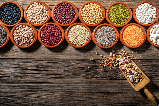 istock Assorted legumes in burlap sacks in a row with wood serving scoop leaving a copy space of rustic wood 1372971149