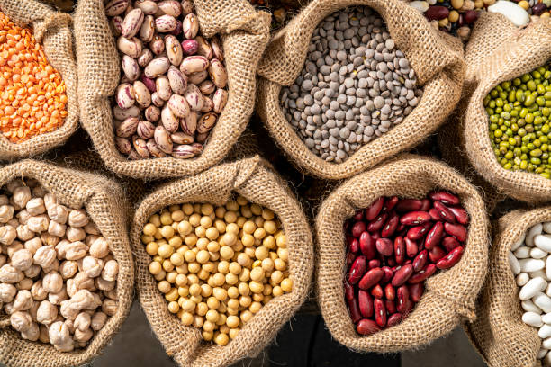 istock Assorted legumes in burlap sacks in a row as a full frame background 1372971255