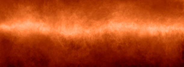istock Orange background autumn fall colors gradient smoky paint texture with bright center and mottled red border in panoramic banner header image design 1372971277