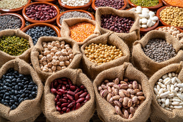 istock Assorted legumes in burlap sacks in a row as a full frame background 1372971420