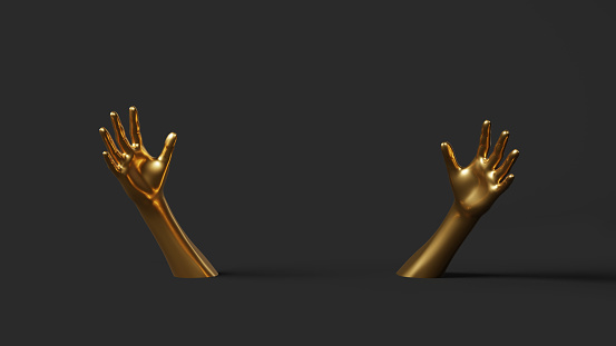 Hand gesture. Hand in gold paint, shiny, metallic. Isolated on black background.
