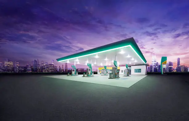 Petrol gas station at night with city building