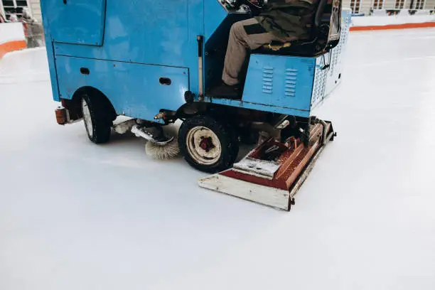 The resurfacer prepares an ice rink, closeup. An ice harvester cleans up the playground in winter. The process of preparing the winter arena
