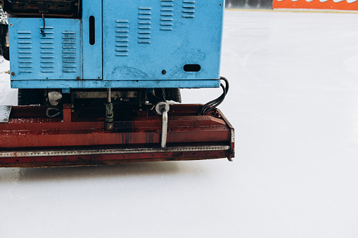 The resurfacer prepares an ice rink, closeup. An ice harvester cleans up the playground in winter. The process of preparing the winter arena