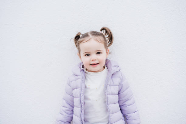 portrait of beautiful caucasian two year old baby girl smiling over white background. childhood portrait of beautiful caucasian two year old baby girl smiling over white background. childhood kids winter coat stock pictures, royalty-free photos & images
