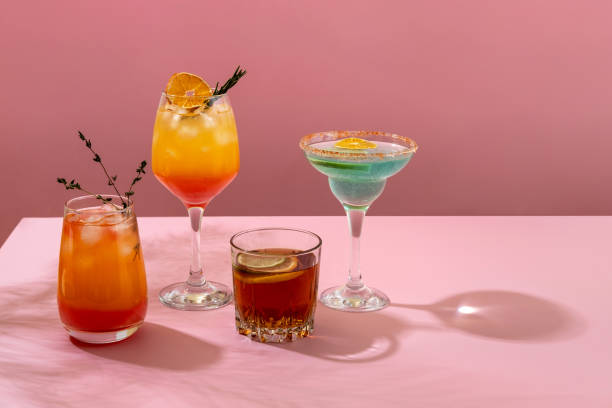 istock Colorful tropical cocktails. Refreshing colorful summer drinks on pink background with shadow palm leaf. Bar drinks menu. 1372976751