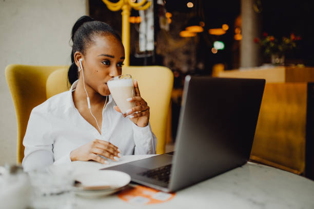 istock A young woman drinks her coffee while using her laptop at the coffee shop 1372977923