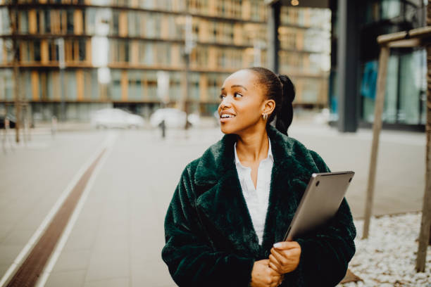 istock Beautiful woman outside with her laptop 1372977963
