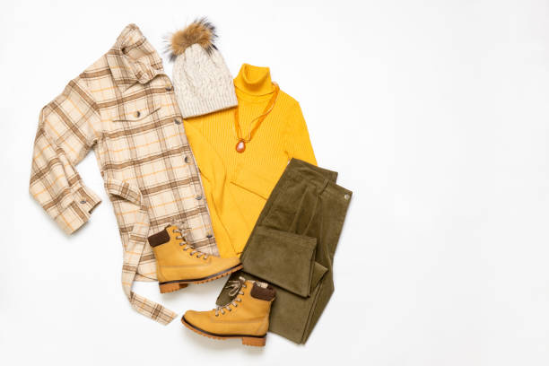 Female winter or autumn stylish clothing set. Plaid checkered shirt, yellow sweater and leather boots, green corduroy trousers, hat with pompom. Trendy fashionable casual clothes. Fashion concept Female winter or autumn stylish clothing set. Plaid checkered shirt, yellow sweater and leather boots, green corduroy trousers, hat with pompom. Trendy fashionable casual clothes. Fashion concept. clubwear stock pictures, royalty-free photos & images