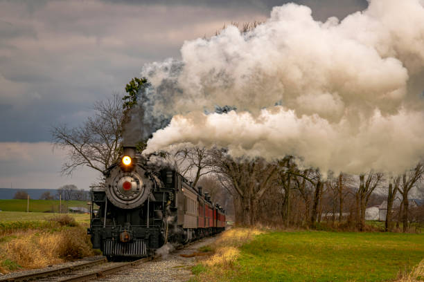 istock View of an Antique Freight Steam Train Blowing Smoke Approaching Thru Trees 1372980355