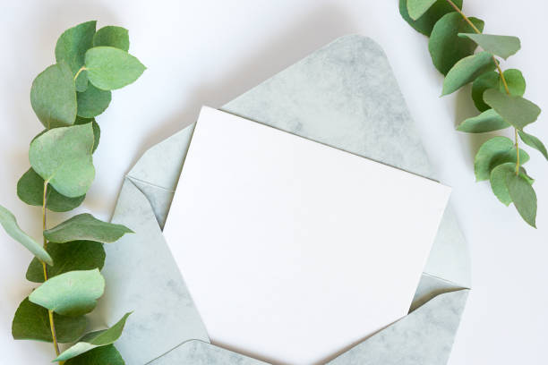 istock Blank white card in green envelope with twigs of eucalyptus 1372980498