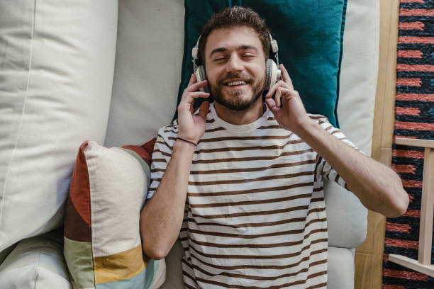 istock Happy man enjoying music at home 1372980502