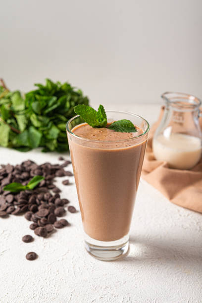 chocolate protein milkshake in glass white kitchen background stock photo