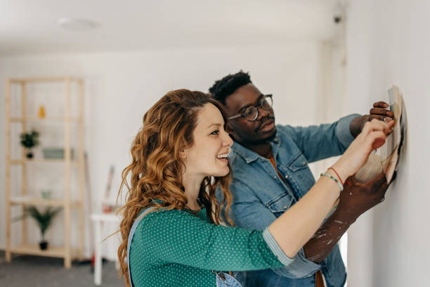 istock Young  couple painting walls 1372984234
