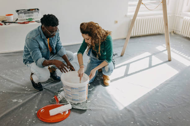 istock Young  couple painting walls 1372984253