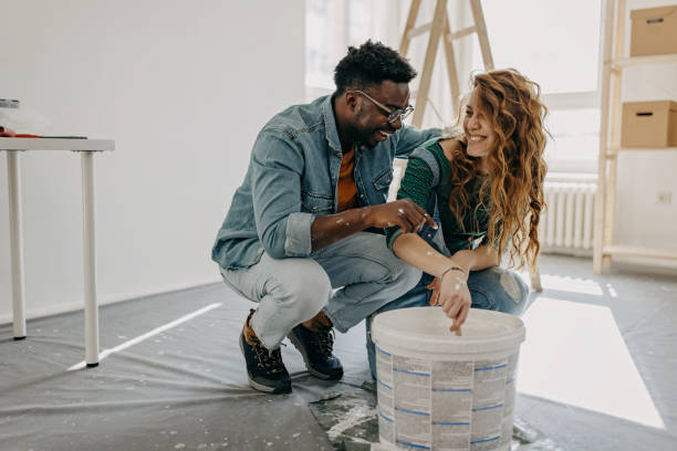 istock Young  couple painting walls 1372984275
