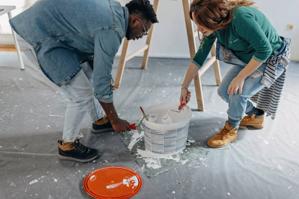 istock Young  couple painting walls 1372984844