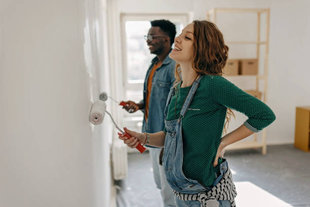Young  couple painting walls