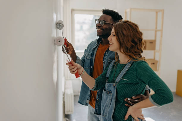 istock Young  couple painting walls 1372984911