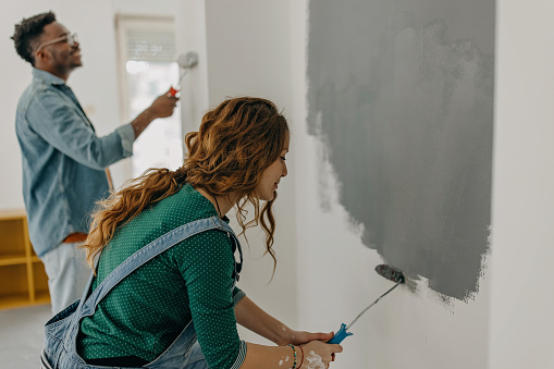 Young  couple painting walls