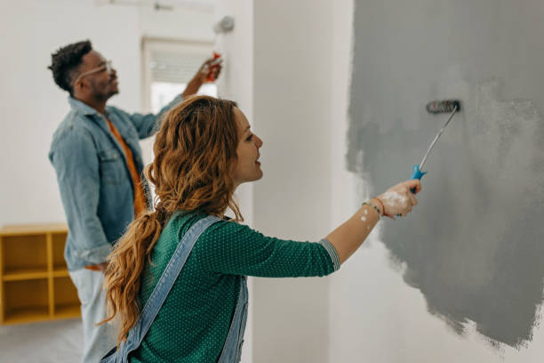 Young  couple painting walls