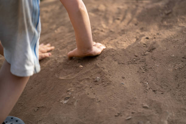 istock Boy climbs up a pile of sand 1372984987