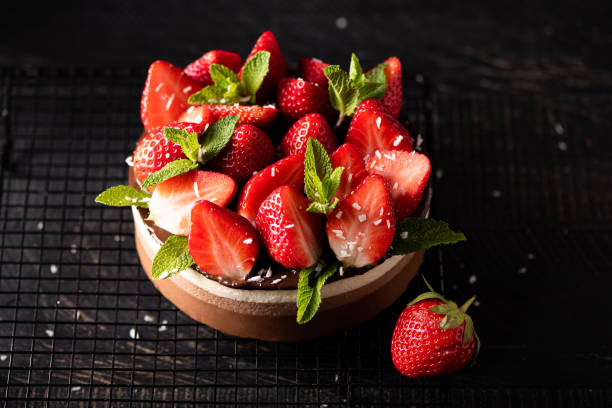 istock round chocolate cake with fresh strawberries and mint 1372985275