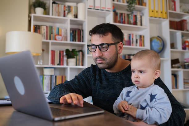 istock man working at home spends time with his son 1372988364