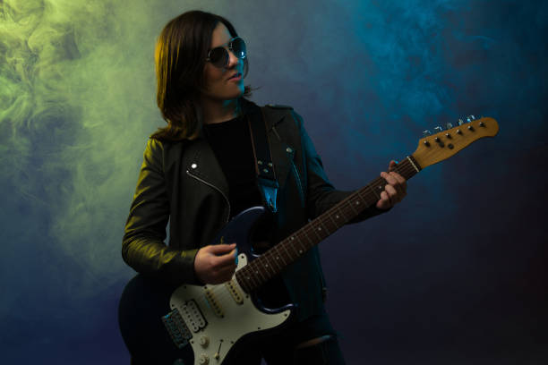 istock Talented female guitarist performing 1372990884
