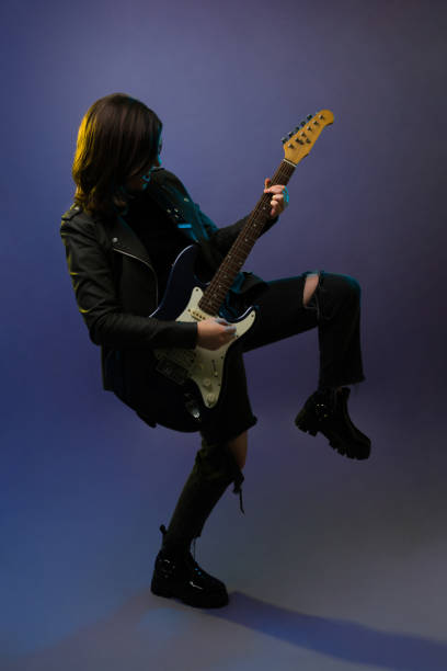 istock Female rock star playing the guitar 1372990889