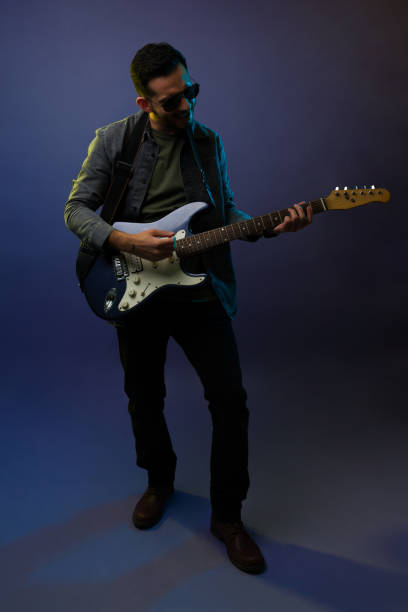 istock Happy rock guitarist playing with passion 1372990962