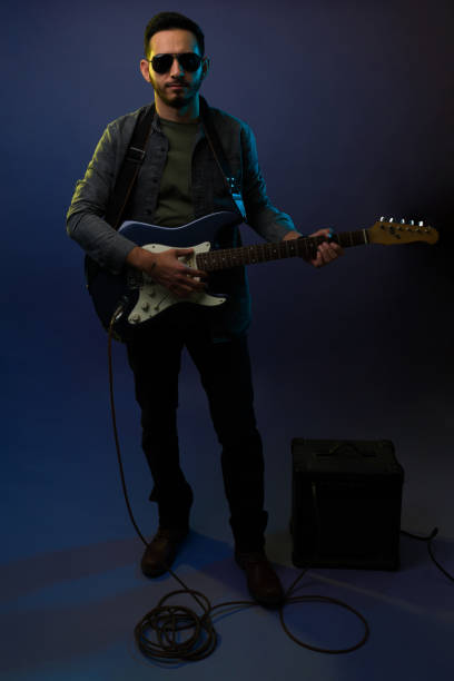 istock Latin rock star playing the guitar 1372991257