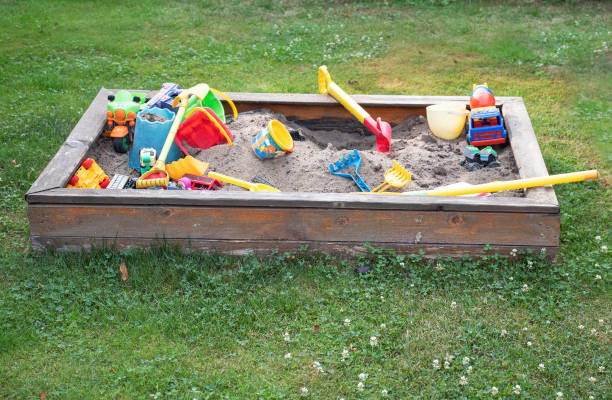 istock Children’s sandbox with toys on green grass 1372994662