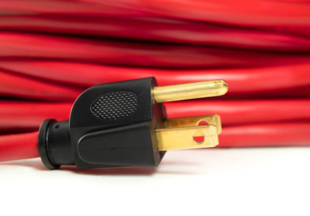 istock Power plug closeup with red extension cord background. 1372996890