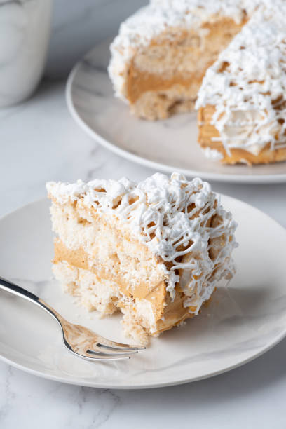 istock A piece of delicious vanilla cake and cake on a light table 1373001130