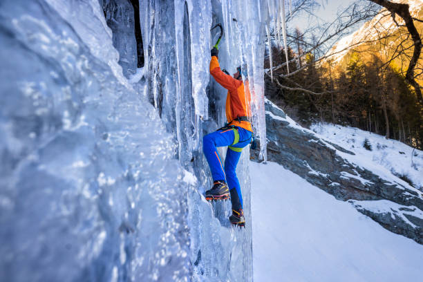 istock Male Ice climber climbing frozen cascade 1373001353