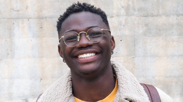 istock Young african american man with glasses looking at camera and smiling 1373002938
