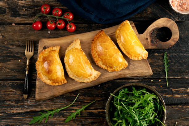 Pasties filled with meat and vegetables Cornish Pasty on wooden dark table Cornish Pasty stock pictures, royalty-free photos & images